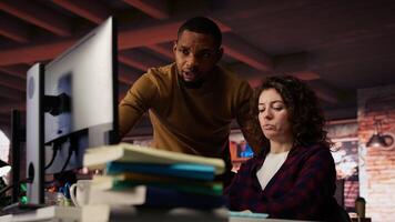AI startup office chief technology officer overseeing woman building application. Manager assisting worker in artificial intelligence software development agency, offering advice, camera B video
