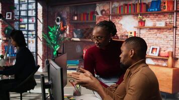 Teamworking programmers creating deep learning models analyzing data in artificial intelligence development agency. African american IT coworkers programming in AI startup office, camera A video