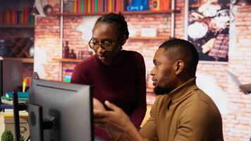 Teamworking programmers creating deep learning models analyzing data in artificial intelligence development agency. African american IT coworkers programming in AI startup office, camera B video