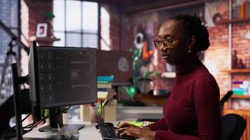 IT startup worker using large language model application to get help with coding tasks. Woman interacting with AI LLM chatbot PC GPT software on PC in software development workplace, camera B video