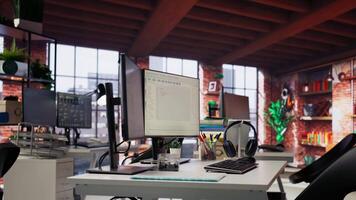 Empty AI tech agency workspace providing custom software development services. Machine learning technology running on PC in startup office to streamline coding process, handheld camera shot video