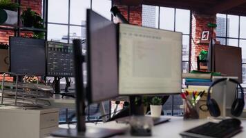 PC in empty IT startup office displaying programming languages used for building applications. Computer screen in software development agency showing code, trucking right shot video