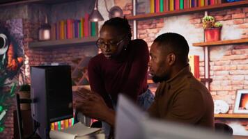 Team of startup workers conducting code review on PC to fix bugs, identifying technical issues with artificial intelligence company software. IT staff members optimizing code using device, camera B video