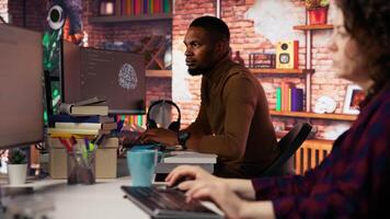 Irked man punching startup office desk in frustration struggling to fix application errors. Upset programmer annoyed by computer bugs while coding in software development agency, camera B video