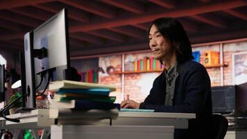 Startup manager leveraging machine learning technology in office to gain competitive edge. Asian Silicon Valley company IT expert working on rapid technological advancement, camera B video