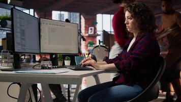 Startup engineer conducting detailed code review to fix bugs, identifying potential performance and technical issues with company software. IT worker debugging and optimizing code, camera A video