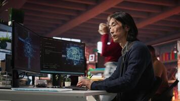 CTO manager in AI startup drinking coffee while coding applications in programming languages. Chief technician officer enjoying hot beverage while doing code testing and quality assurance, camera A video