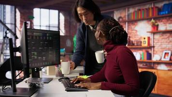 Tired admin in AI startup office having strained eyesight from overworking, getting help from senior manger. Woman removing eyeglasses to rub eyes, encouraged by team leader to take break, camera B video