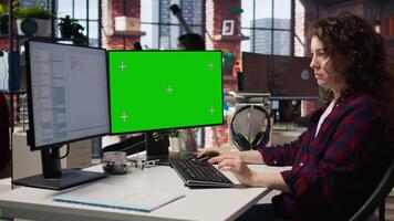 Woman coding in AI startup office using mockup PC, building scalable solutions for businesses. AI industry startup technician leveraging machine learning technology on green screen computer, camera A video