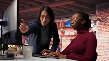 Man in AI startup office CTO position overseeing software engineer implementing machine learning. Artificial intelligence tech venture supervisor helps employee fix code bugs, camera B video