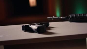 Rifle and pistol at shooting range to be used in training designed to increase safety and survivability in combat, close up. Military handguns to be used in practice, handheld camera shot video