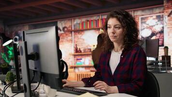 Employee working in innovative startup office using programming languages to build application. Software development agency IT specialist optimizing code, typing on computer keyboard, camera A video