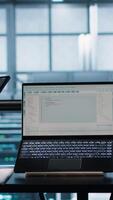 Vertical Programmers using AI technology on laptop and tablet in data center employing machine learning models. Devices used by artificial intelligence IT experts in server farm, camera A video