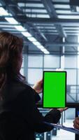 Vertical Engineers using green screen tablet in data center, checking infrastructure reliability, writing in clipboard. Workers using mockup device in server room, managing server virtualization, camera B video