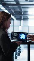 Vertical Software developers in data center use AI technology on tablet to optimize storage volumes. IT specialists in server hub facility using artificial intelligence to ensure seamless operations, camera B video