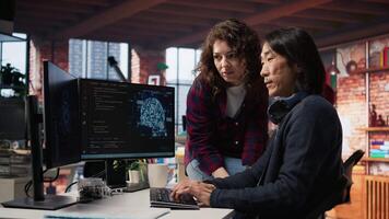 Coworkers collaborating in AI tech agency providing software development services. Teamworking startup office colleagues using artificial intelligence to streamline coding process, camera A video