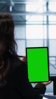 Vertical Engineers using green screen tablet in data center, checking infrastructure reliability, writing in clipboard. Workers using mockup device in server room, managing server virtualization, camera A video
