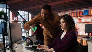 AI startup office chief technology officer overseeing woman building application. Manager assisting worker in artificial intelligence software development agency, offering advice, camera A video