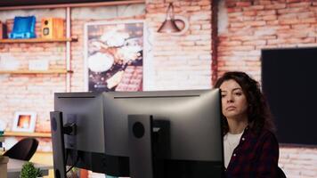 Company personnel sitting at desks in startup office, imputing data on computers. Man entering venture agency room holding laptop next to staff members in solving tasks during job shift, camera B video