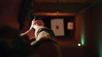Man enjoying recreational shooting experience in firing range, checking if he shot bullseye. Person practicing with weapons in safe environment at shooting range company, hitting targets, camera A video