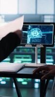 Vertical Manager meeting with client in data center using artificial intelligence tech, reaching deal. People doing handshake in AI based server farm after checking files and finishing transaction, camera A video
