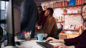 Team of startup workers conducting code review on PC to fix bugs, identifying technical issues with artificial intelligence company software. IT staff members optimizing code using device, camera A video