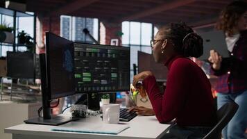 AI startup engineer eating snack while waiting code to finish compiling, annoyed by long wait. Irked software development agency employee consuming food, exasperated by sluggish PC, camera A video