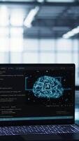 Vertical Laptop in front of data center engineers in blurry background deploying artificial intelligence driven management tools. AI driven notebook used for overseeing server clusters, camera B close up video