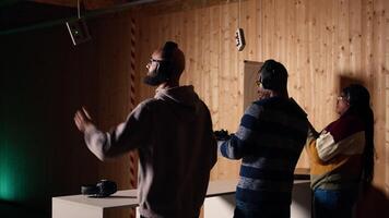 Company coworkers enjoying recreational shooting experience in firing range during teambuilding. Workplace colleagues practicing with weapons in safe shooting range environment, camera A video