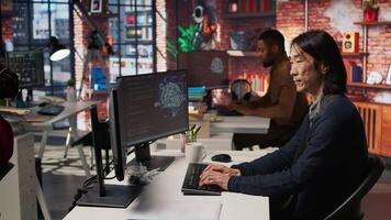 AI startup office chief technology officer drinking coffee and building application. Senior manager enjoying hot beverage while working in artificial intelligence software development agency, camera A video