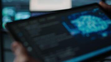 Programmer in data center using AI tech on tablet, testing equipment failover scenarios. Server farm IT specialist uses artificial intelligence on device, ensuring data accessibility, camera A closeup video