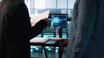 Manager meeting with client in data center using artificial intelligence tech, reaching deal. People doing handshake in AI based server farm after checking files and finishing transaction, camera A video