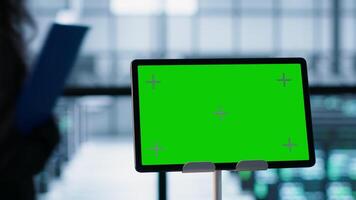 Close up of chroma key tablet next to server room data scientists conducting security audits, preventing bugs. Green screen device and man working with colleague in data center, camera A video
