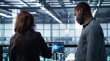 Manager meeting with client in data center using artificial intelligence tech, reaching deal. People doing handshake in AI based server farm after checking files and finishing transaction, camera B video