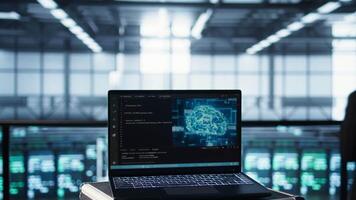 Focus on laptop used by teamworking data center computer scientists in background using artificial intelligence. Notebook screen with neural networks doing computing processes, camera B close up video