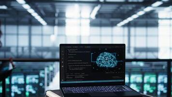 Laptop in front of data center engineers in blurry background deploying artificial intelligence driven management tools. AI driven notebook used for overseeing server clusters, camera B close up video