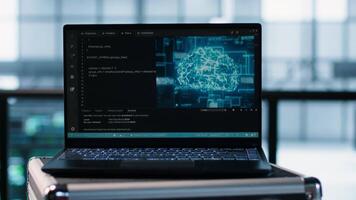 Focus on laptop used by teamworking data center computer scientists in background using artificial intelligence. Notebook screen with neural networks doing computing processes, camera A close up video