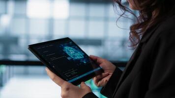 Engineer in data center with tablet integrating AI driven automation tools. Worker ensuring continuous uptime of server room using artificial intelligence, managing data flows, camera A video