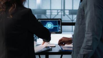 Manager meeting with client in data center to review files, doing handshake after finalizing deal. Server room supervisor reaching agreement with customer after checking documentation, camera A video