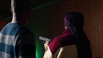 Shooting gallery worker teaching student how to hold pistol, close up. Firing range specialist providing guide to woman learning how to achieve high level of proficiency with firearms, camera A video