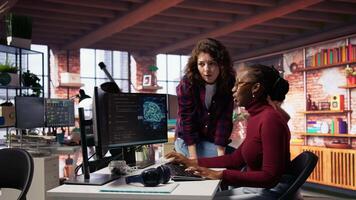 Teamworking engineers coding advanced AI algorithm and machine learning models enhancing automation. Employee talking with coworker in artificial intelligence Silicon Valley workspace, camera B video