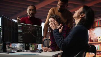 Startup team in office disappointed after watching stock exchange valuation decline because of market volatility. Upset venture workers analyzing charts, seeing stock valuation drop, camera A video