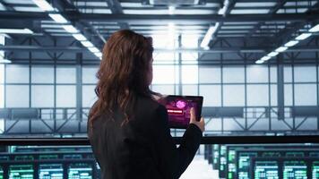 Data center engineer stressed by cyberattack affecting devices, trying to protect critical systems. Server room admin receiving threat detection alert on device, camera B video