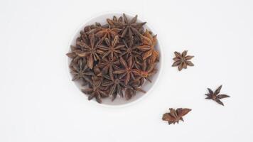 Top View of A Bunch of Dried Star Anise Spice on Bowl on White Background photo