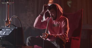 Man with hookah pausing videogame video