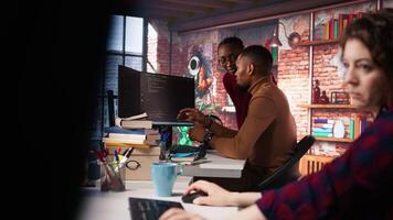 Startup staff members gathered together to conduct code review to fix bugs, identifying technical issues. Artificial intelligence company coworkers doing brainstorming, optimizing code, camera A video
