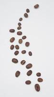 Scattered Coffee Beans on White Background photo