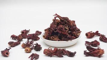 Top View of Scattered and A Bunch of Dried Roselle on White Background photo