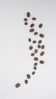 Top View of Scattered Coffee Beans on White Background photo