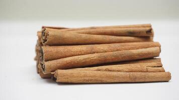 Pile of Dried Cinnamon Spice with Selective Focus on White Background photo